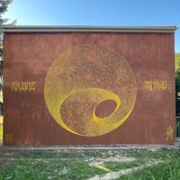 a wall with a yellow yin yang symbol on it