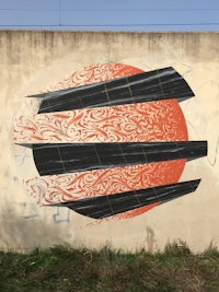 a painting of a sun on a wall